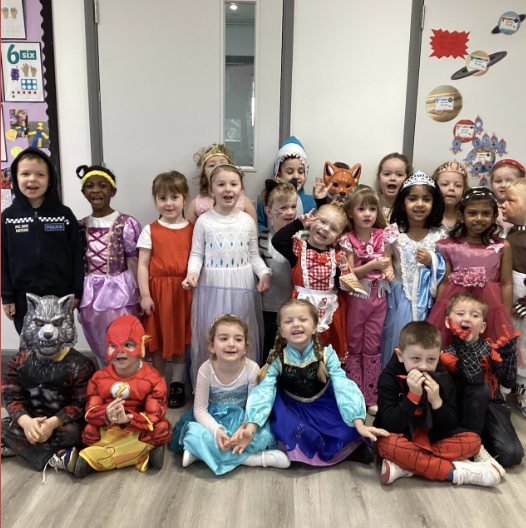A group of students in costumes, smiling